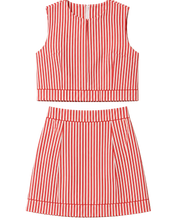 Load image into Gallery viewer, A sleeveless crop top and matching pleated skirt set in a red and white vertical stripe pattern, displayed flat against a light beige background.