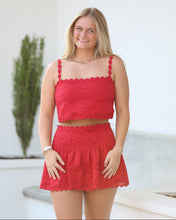 Load image into Gallery viewer, Woman wearing a red dress with white lace details against a light background