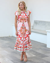 Load image into Gallery viewer, Woman wearing a colorful dress with a patterned design in an indoor setting.