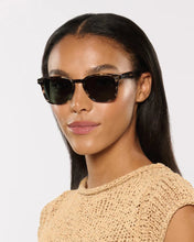 Load image into Gallery viewer, Woman wearing sunglasses with a plain background