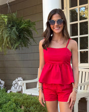 Load image into Gallery viewer, Woman in a red outfit standing on a porch