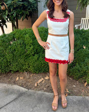 Load image into Gallery viewer, Woman wearing a white and red outfit standing outdoors.