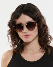 Load image into Gallery viewer, Woman wearing sunglasses with a neutral background